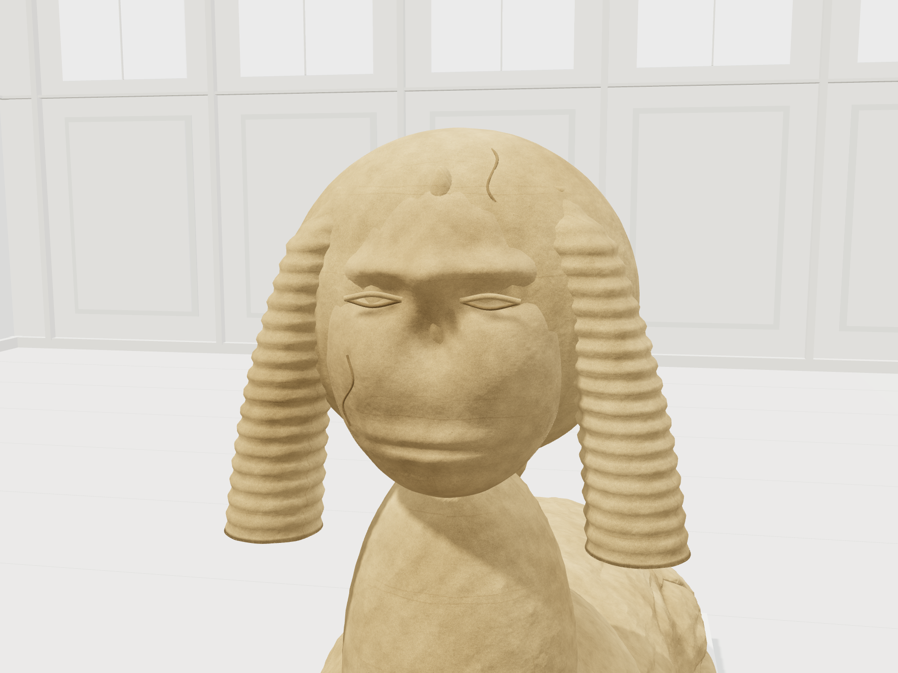 Close three-dimensional view of the carved face and folded headdress